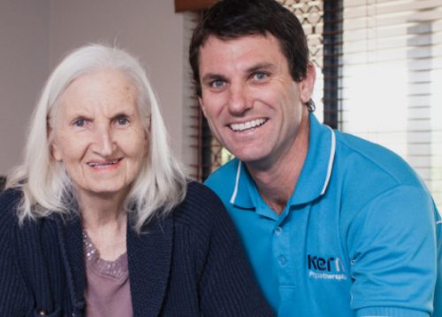 Mark Kerns smiles with an elder female client