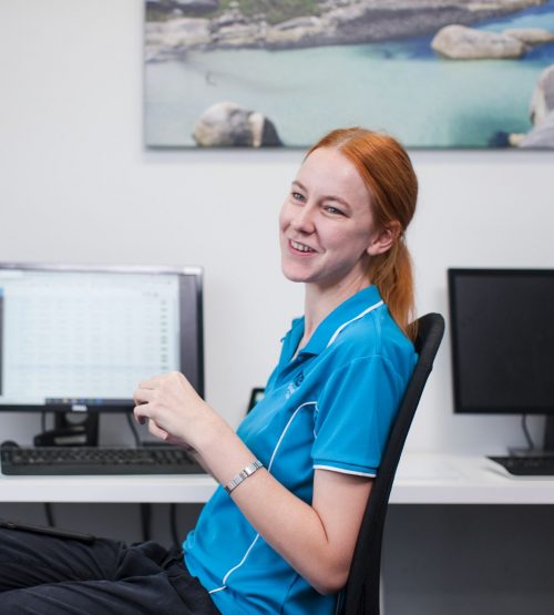 Two Kern Allied Health staff members talk at their work desk